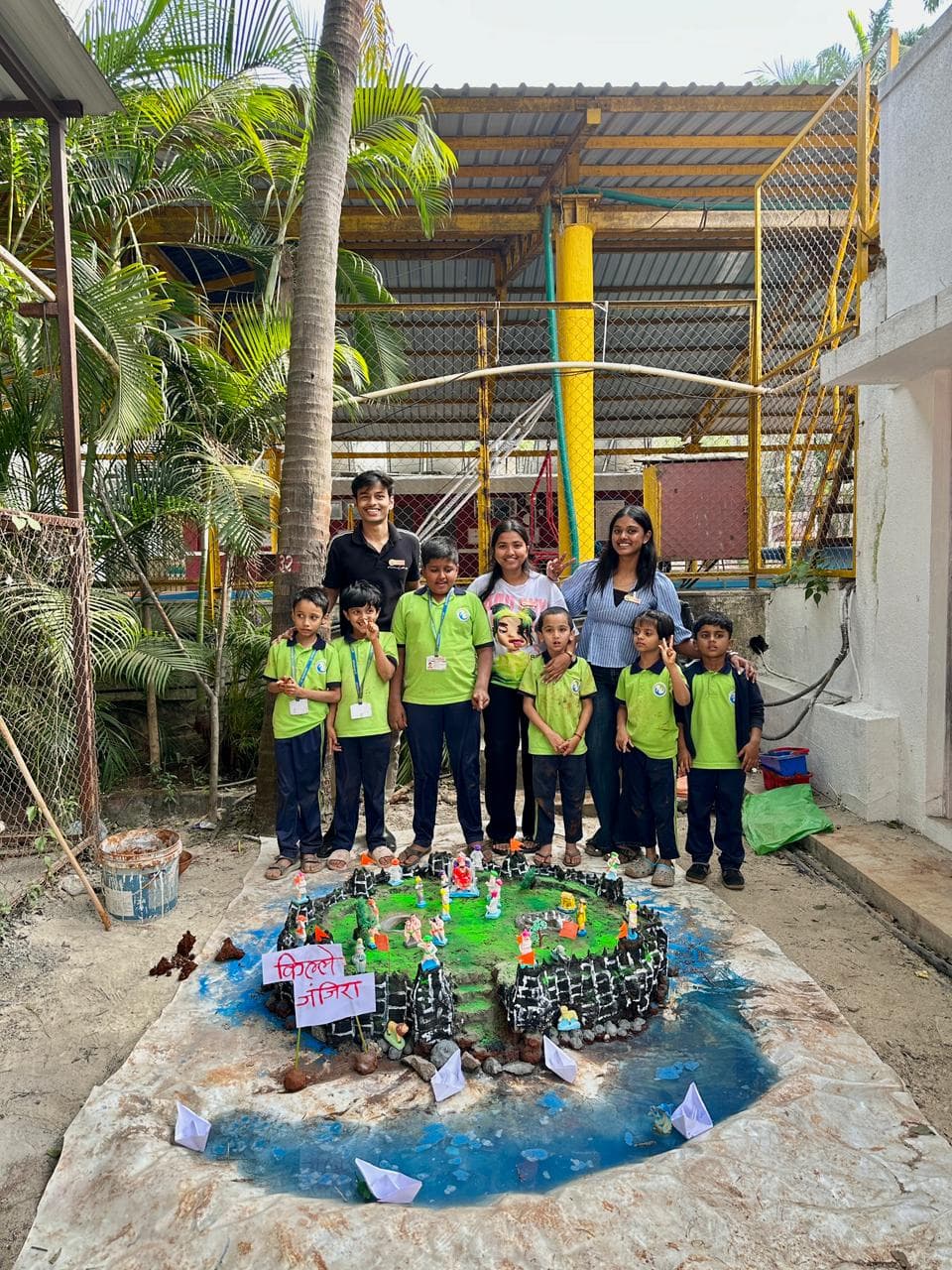 Members with the young participants and their creations.