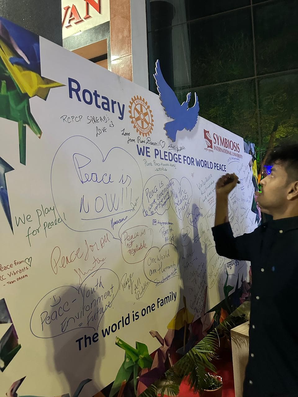 Signing the peace pledge — 'The world is one family.'